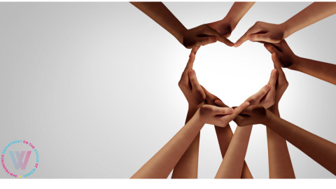 A group of diverse hands form a heart